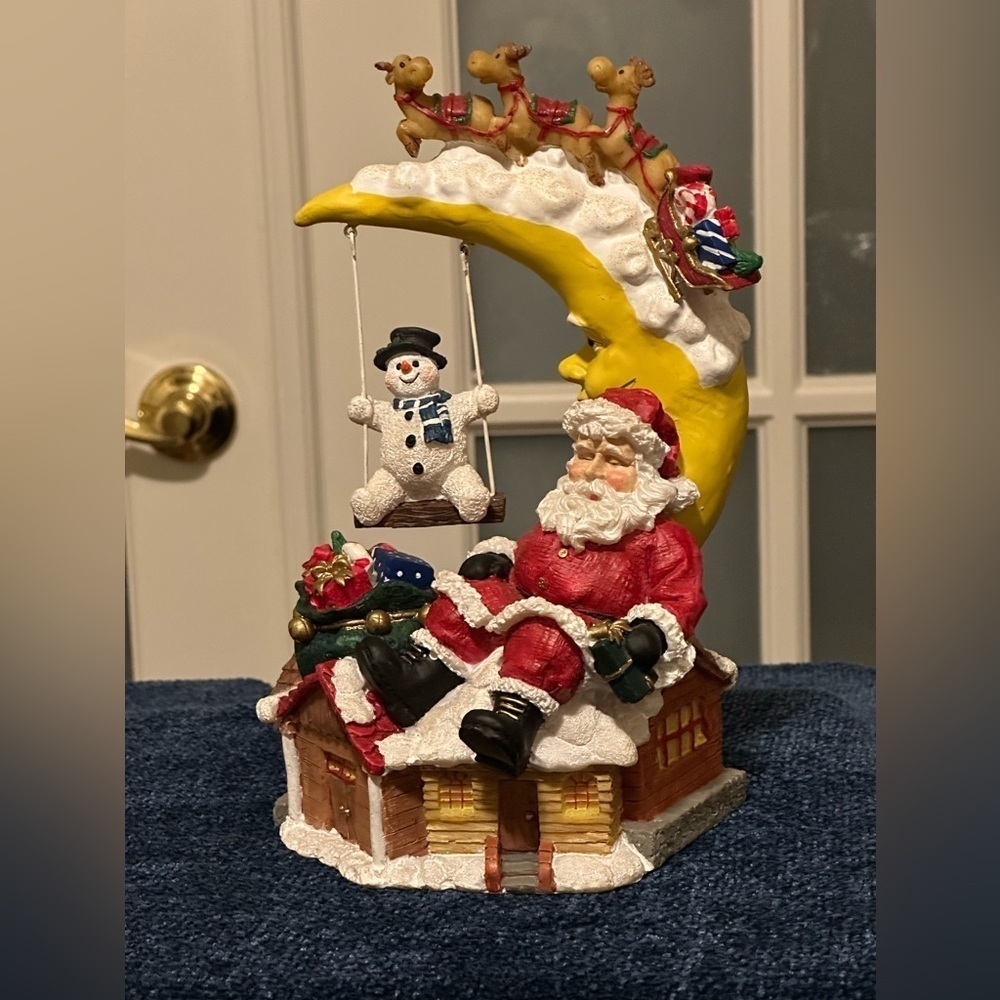 Sleepy Santa rests while a snow buddy swings. Missing bottom